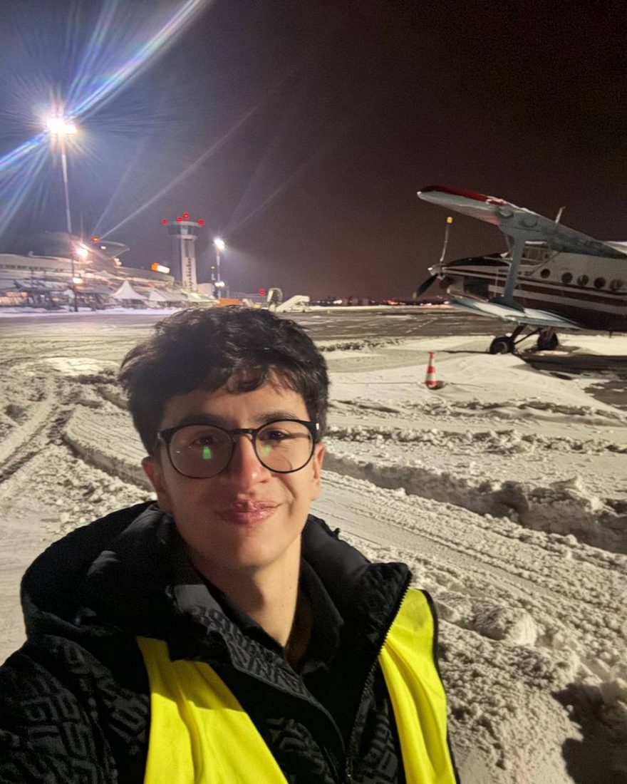 Tymur, founder of RightSeat, on an airport apron at night next to an aircraft